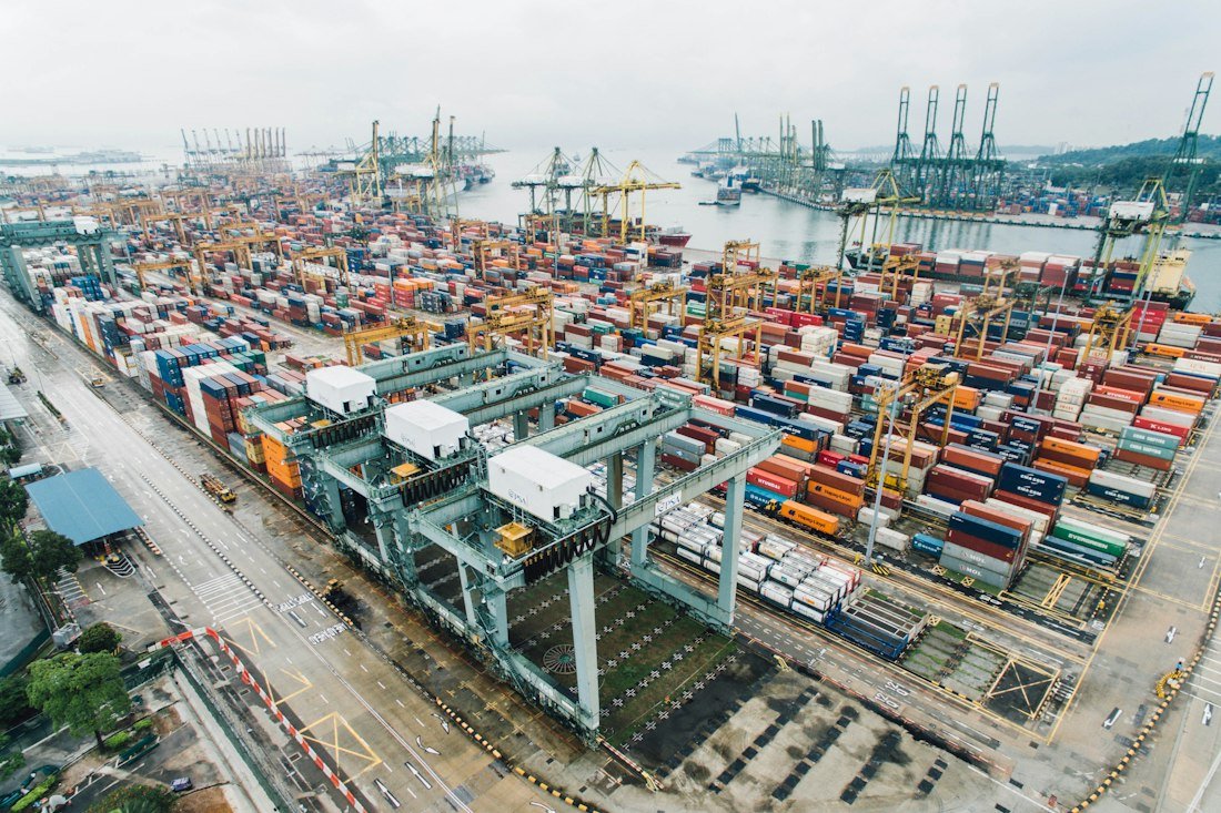 Aerial view of shipping containers and gantry cranes at a freight terminal