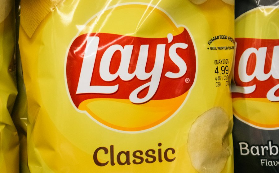 Bags of Lay's Classic potato chips on a store shelf