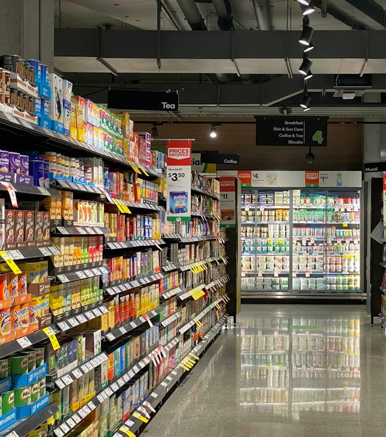 Supermarket shelves stocked with packaged foods, drinks and everyday consumer products