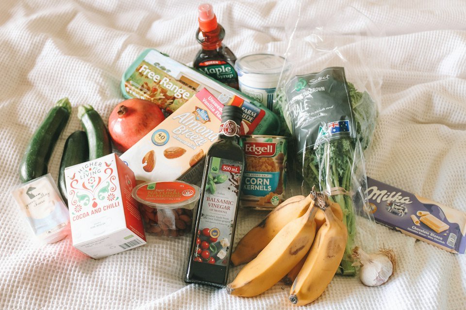 Assorted packaged groceries, sauces, snacks and fresh produce from a range of consumer brands