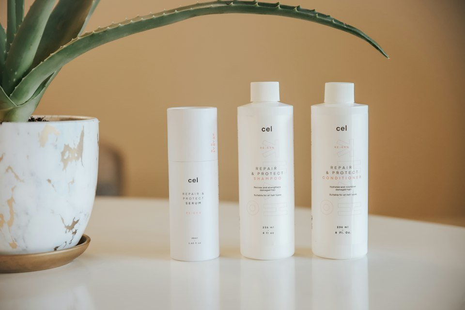 Row of plain white product bottles with minimal neutral labels